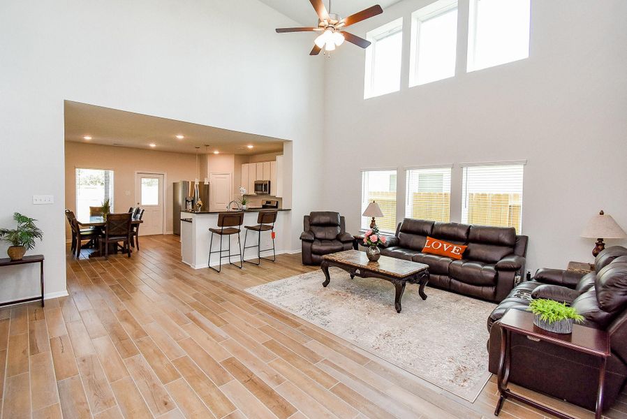 Soaring ceilings and an abundance of windows fill the living room with natural light. Soaring ceilings and an abundance of windows fill the living room with natural light.