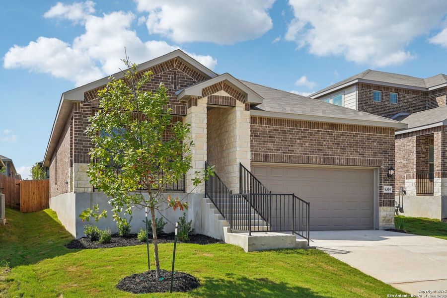 Front exterior of a new home in Comanche Ridge, San Antonio, TX, highlighting curb appeal (Image 1).
