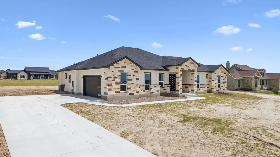 Front exterior of a new home in , La Vernia, TX, highlighting curb appeal (Image 2). Front exterior of a new home in , La Vernia, TX, highlighting curb appeal (Image 2).