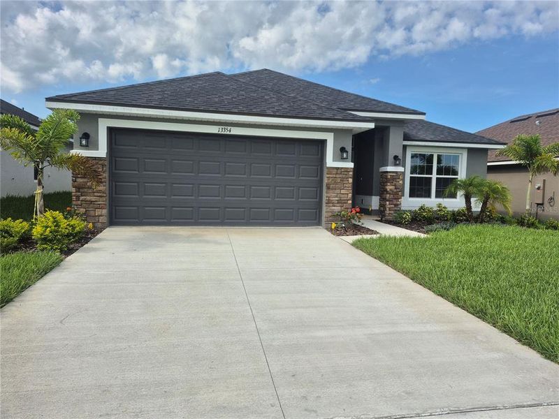 Front exterior of a new home in Abbey Glen, Dade City, FL, highlighting curb appeal (Image 2). Front exterior of a new home in Abbey Glen, Dade City, FL, highlighting curb appeal (Image 2).