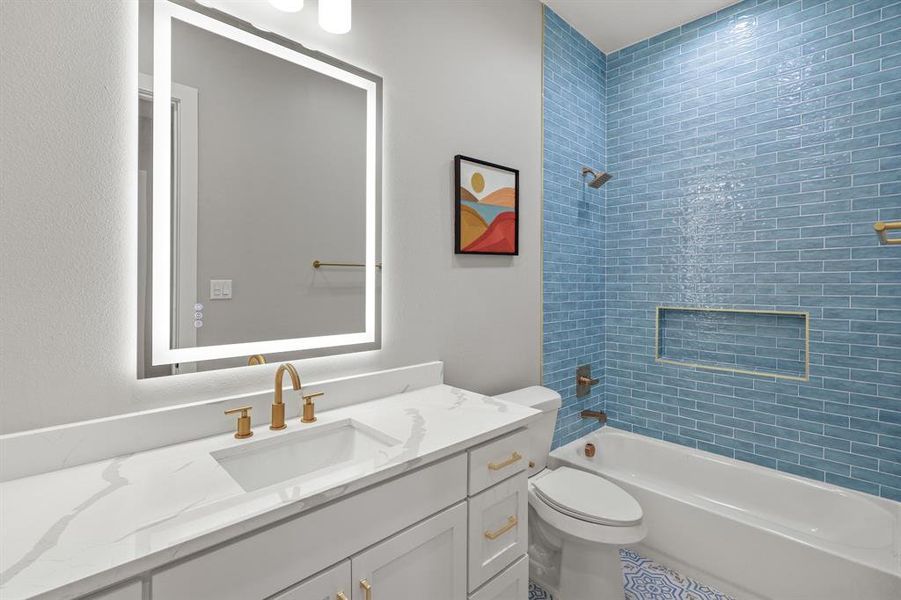 Full bathroom with vanity, toilet, and tiled shower / bath combo