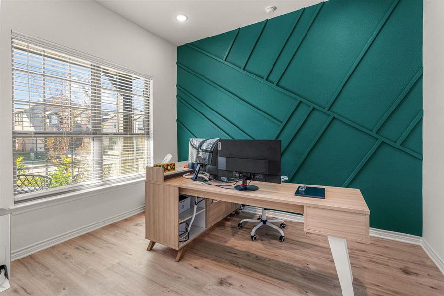 Home office with hardwood / wood-style flooring