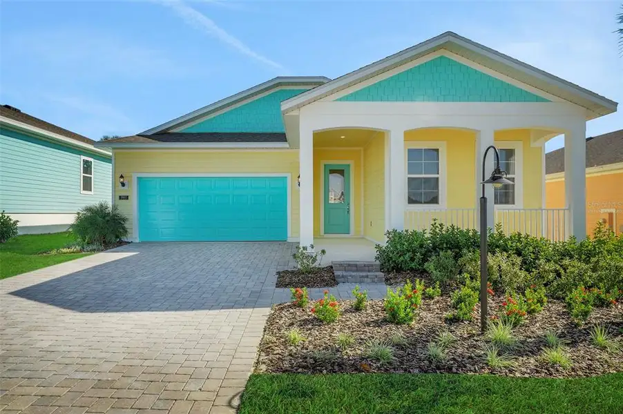 Front exterior of a new home in Green Key Village, Lady Lake, FL, highlighting curb appeal (Image 1). Front exterior of a new home in Green Key Village, Lady Lake, FL, highlighting curb appeal (Image 1).