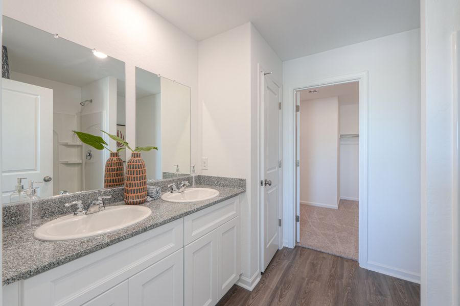 A bathroom with a sink and a mirror. A bathroom with a sink and a mirror.