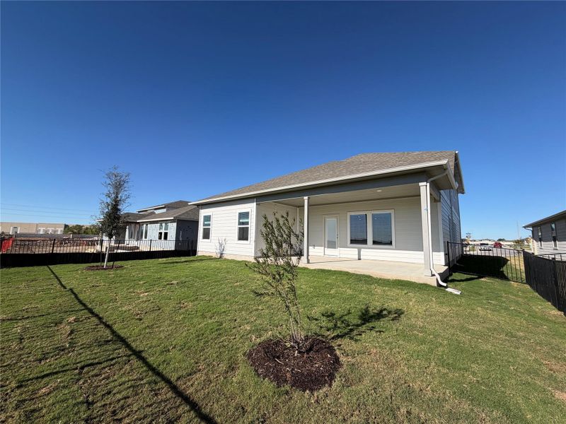 Back of property with a fenced backyard, a patio area, and a shingled roof Back of property with a fenced backyard, a patio area, and a shingled roof