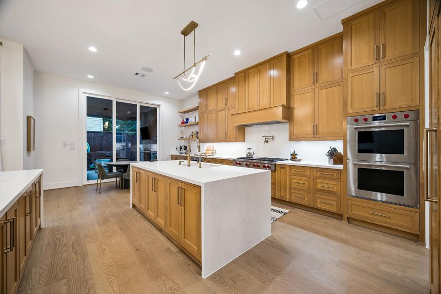 The breakfast area seamlessly opens to the covered lanai and outdoor kitchen, creating an ideal space for indoor-outdoor living.