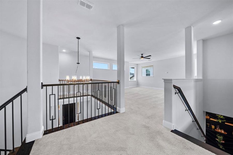 Hall with an upstairs landing, recessed lighting, a chandelier, and carpet