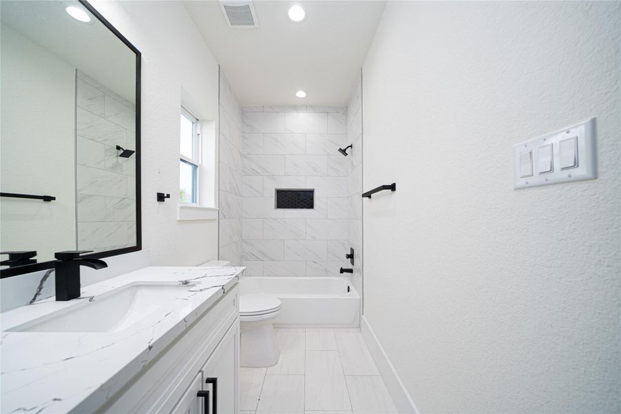 The hallway leads past the convenient washer and dryer to a pristine Jack-and-Jill bathroom, offering a clean, well-maintained, and private space for family or guests. Thoughtfully designed and move-in ready, this bathroom is perfectly prepared to welcome the new year in your new home. The hallway leads past the convenient washer and dryer to a pristine Jack-and-Jill bathroom, offering a clean, well-maintained, and private space for family or guests. Thoughtfully designed and move-in ready, this bathroom is perfectly prepared to welcome the new year in your new home.
