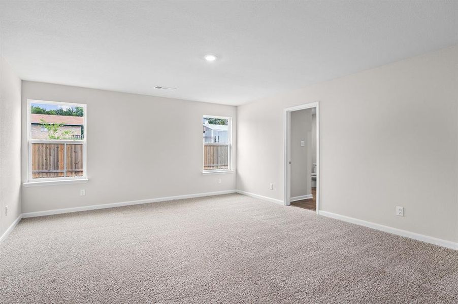 Carpeted spare room featuring baseboards Carpeted spare room featuring baseboards