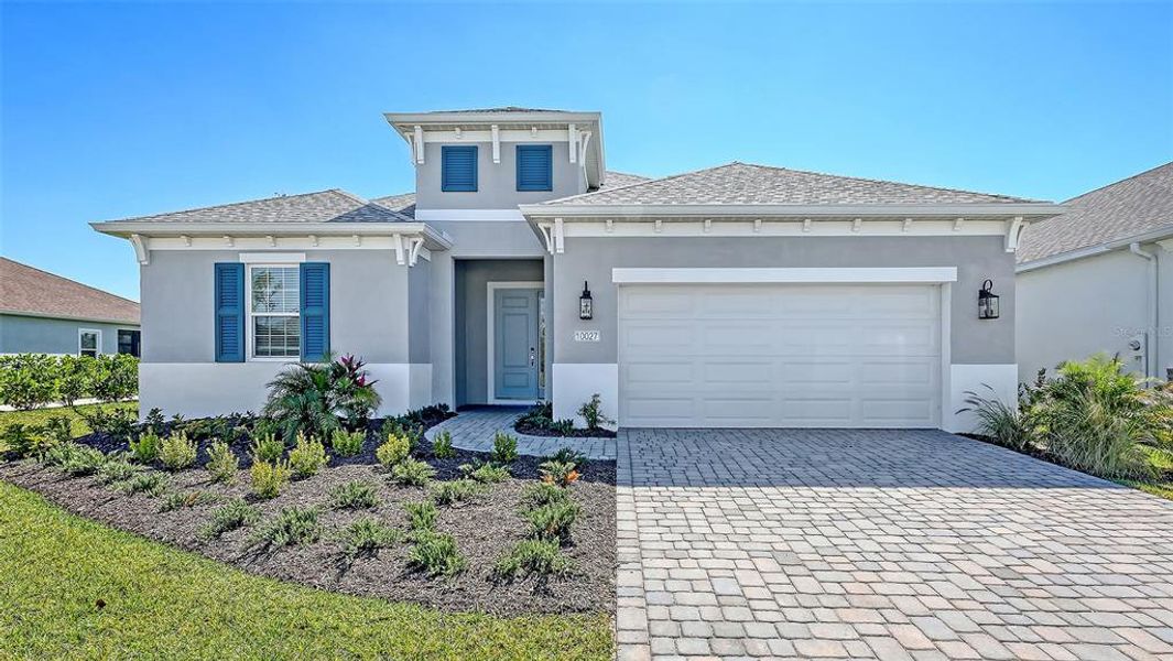 Front exterior of a new home in Wildleaf, Parrish, FL, highlighting curb appeal (Image 1). Front exterior of a new home in Wildleaf, Parrish, FL, highlighting curb appeal (Image 1).