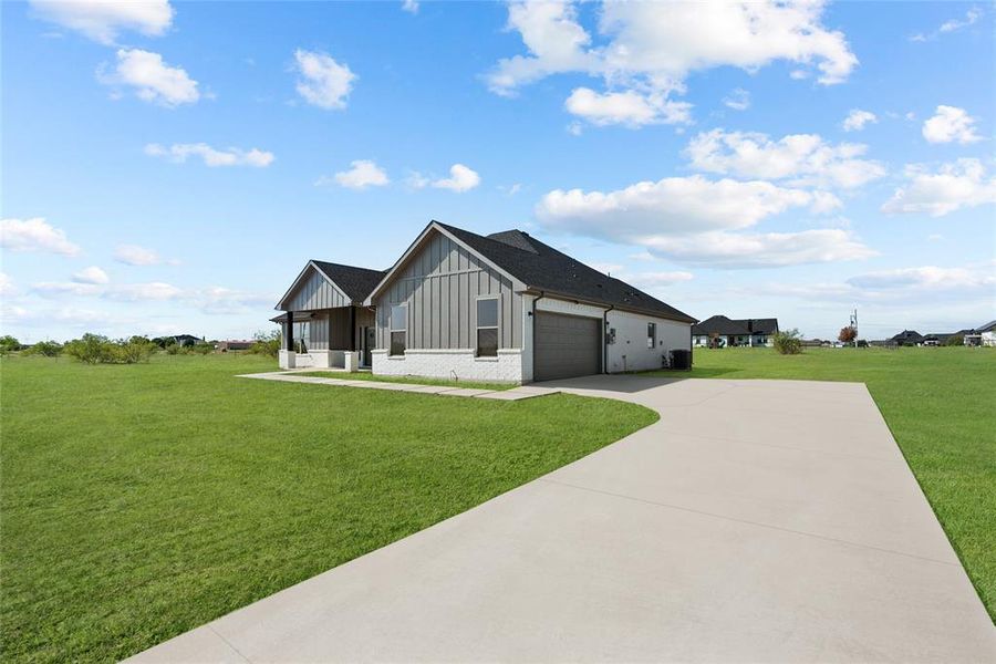 View of front of house with a front lawn and a garage