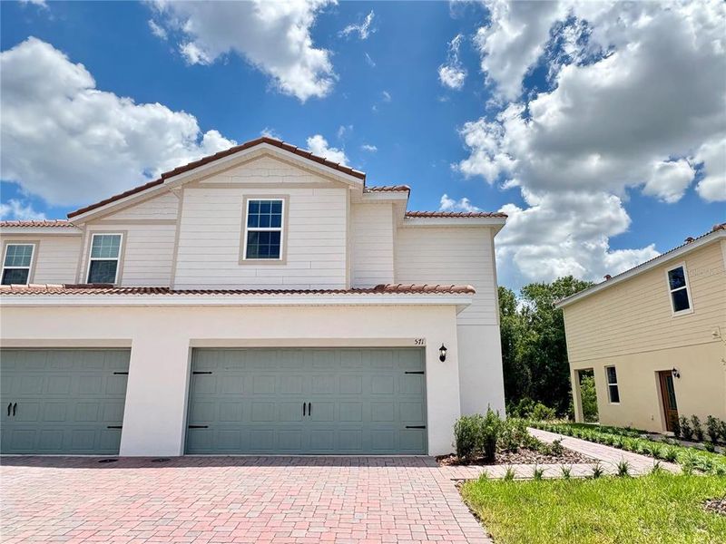 Front exterior of a new home in , Poinciana, FL, highlighting curb appeal (Image 1). Front exterior of a new home in , Poinciana, FL, highlighting curb appeal (Image 1).