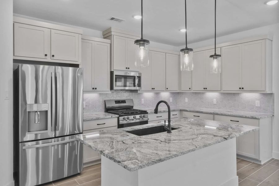 Representative furnished interior of a home built from the Carriagehouse by Chesmar Homes in Meridiana Townhomes, Iowa Colony (Image 5).