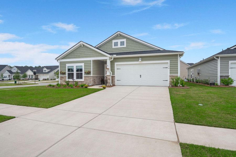 Front exterior of a new home in Horizons at Summers Corner | 55+: The Legends, Summerville, SC, highlighting curb appeal (Image 25).