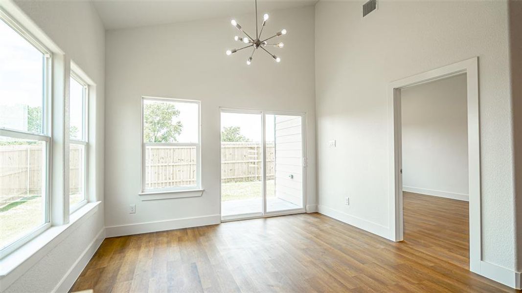 wood-style vinyl plank floors, and an inviting chandelier