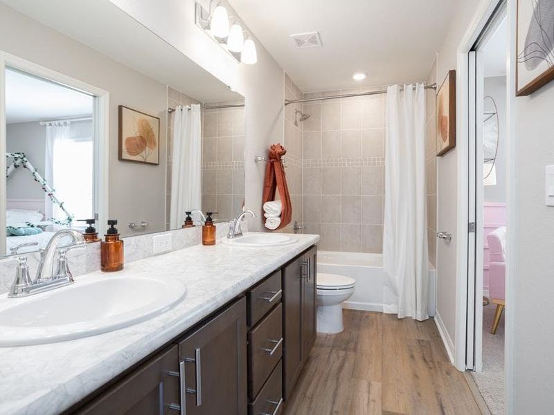 A Jack-and-Jill bath serves the secondary bedrooms - Magnolia townhome by Highland Homes A Jack-and-Jill bath serves the secondary bedrooms - Magnolia townhome by Highland Homes