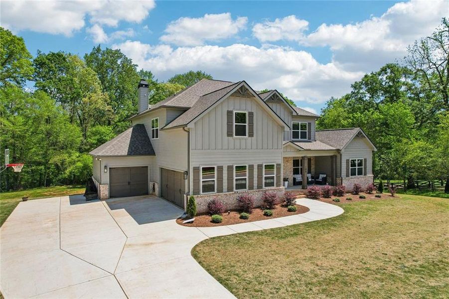 Front exterior of a new home in , Hoschton, GA, highlighting curb appeal (Image 24).