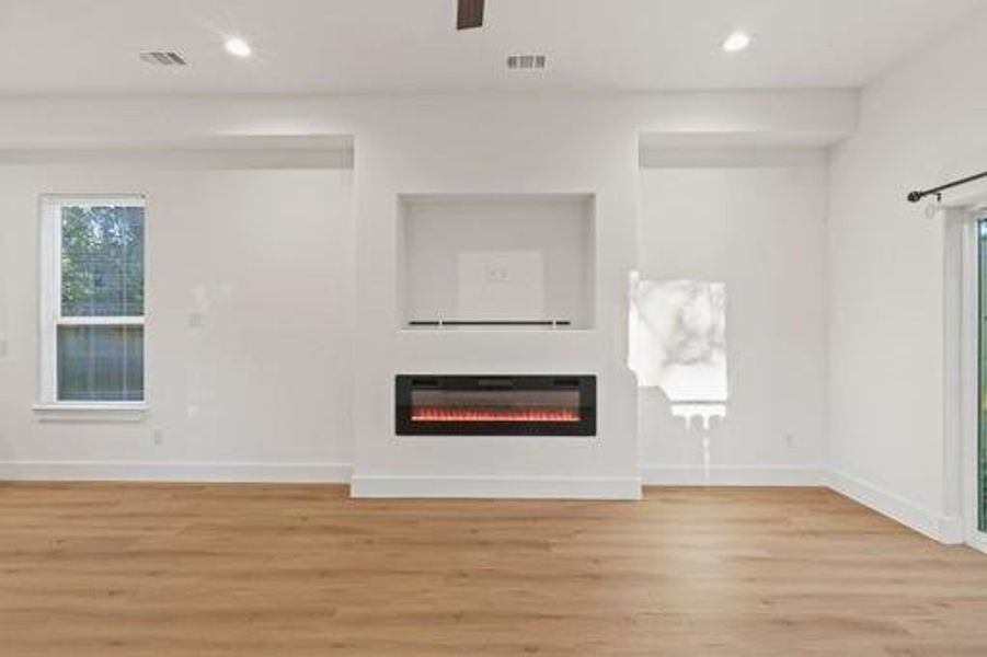 Unfurnished living room with light hardwood / wood-style floors