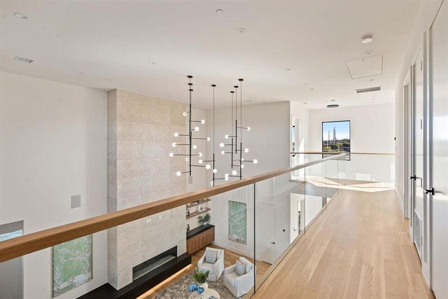 Upstairs balcony overlooking the great room and modern fireplace. Upstairs balcony overlooking the great room and modern fireplace.