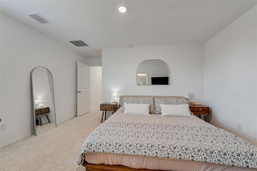 Bedroom with light colored carpet and baseboards Bedroom with light colored carpet and baseboards
