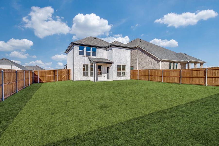 Rear view of property with a patio, brick siding, and a fenced backyard Rear view of property with a patio, brick siding, and a fenced backyard