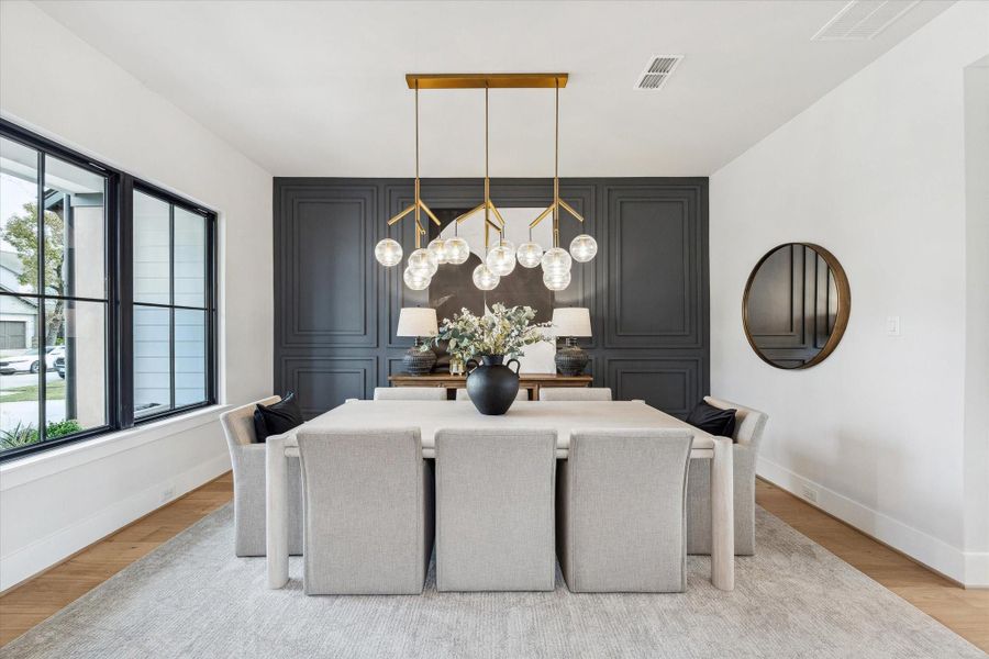Formal dining room featuring unique accent wall paneling that adds the perfect amount of contrast and character to the space.