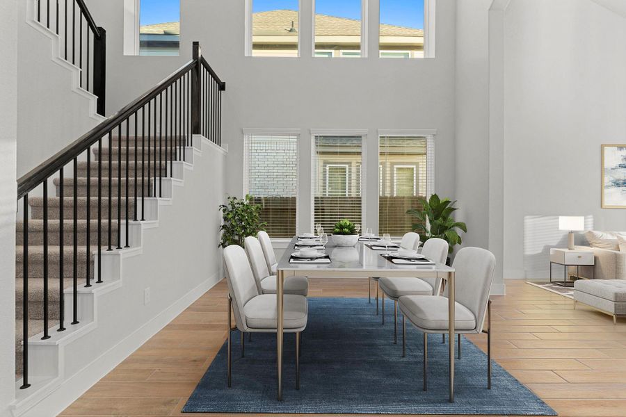 The open layout flows effortlessly from the dining area into the gourmet kitchen, creating a seamless transition ideal for both entertaining and daily living. The tall ceilings and natural light enhance the home’s modern, airy ambiance. *Staged Photo* The open layout flows effortlessly from the dining area into the gourmet kitchen, creating a seamless transition ideal for both entertaining and daily living. The tall ceilings and natural light enhance the home’s modern, airy ambiance. *Staged Photo*