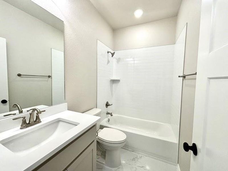 Full bathroom featuring vanity, bathtub / shower combination, and toilet