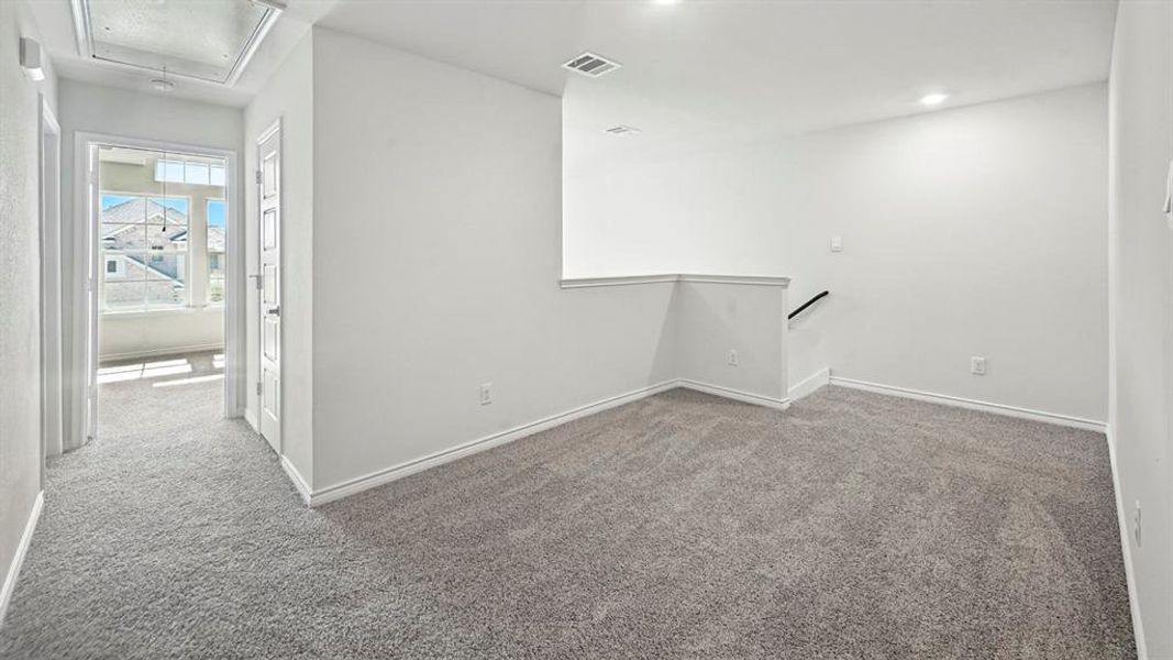 Unfurnished room featuring attic access and light colored carpet Unfurnished room featuring attic access and light colored carpet