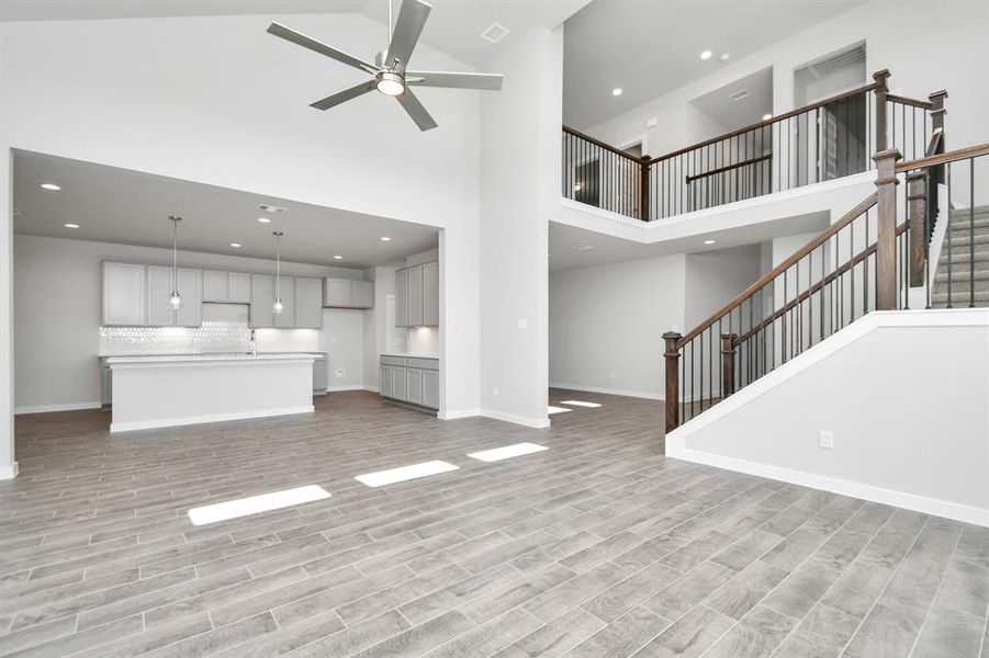 Take another glimpse into the heart of the home with this additional view of the family room—a sprawling space ready to accommodate all your gatherings. Sample photo of completed home with similar floor plan. As-built interior colors and selections may vary.