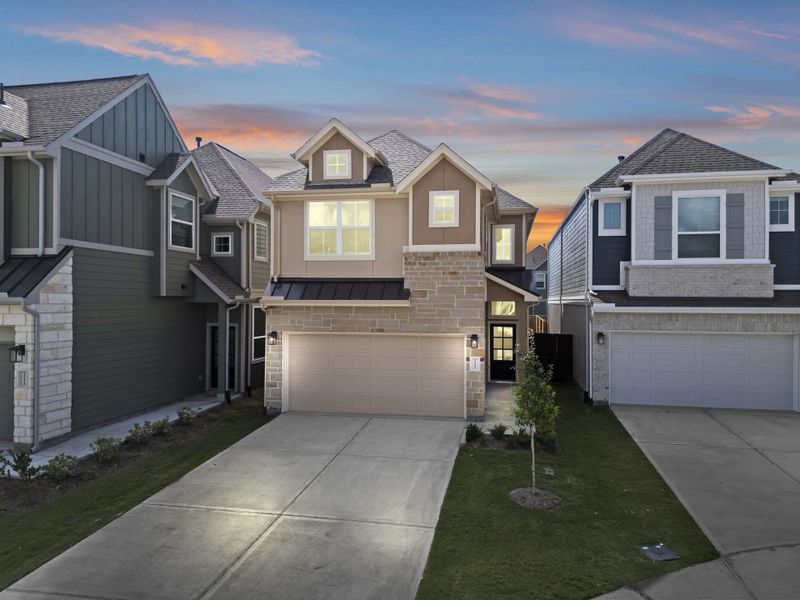 Front exterior of a new home in Meridiana, Manvel, TX, highlighting curb appeal (Image 18).
