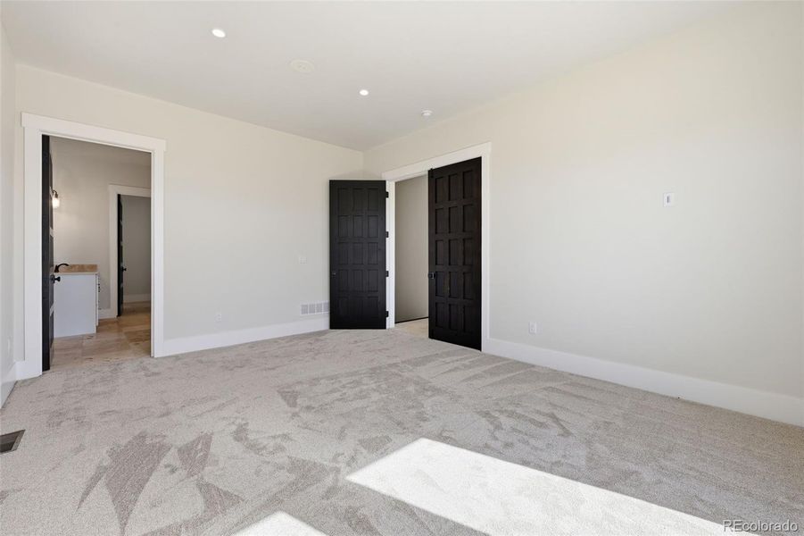 Master Bedroom looking into bath suite and privacy doors to right Master Bedroom looking into bath suite and privacy doors to right
