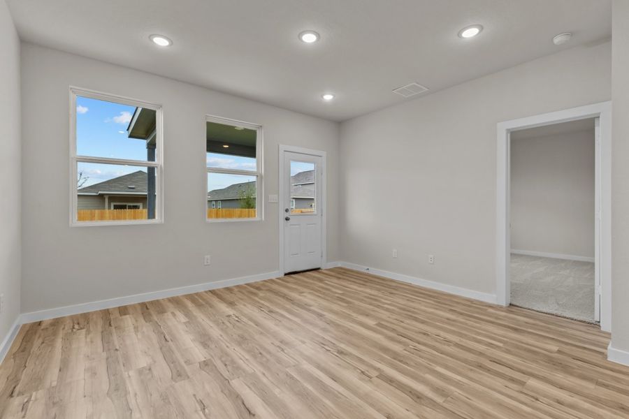 A room with a wood floor and a wood floor with a window. A room with a wood floor and a wood floor with a window.