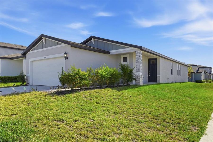 Front exterior of a new home in Park East, Plant City, FL, highlighting curb appeal (Image 25). Front exterior of a new home in Park East, Plant City, FL, highlighting curb appeal (Image 25).
