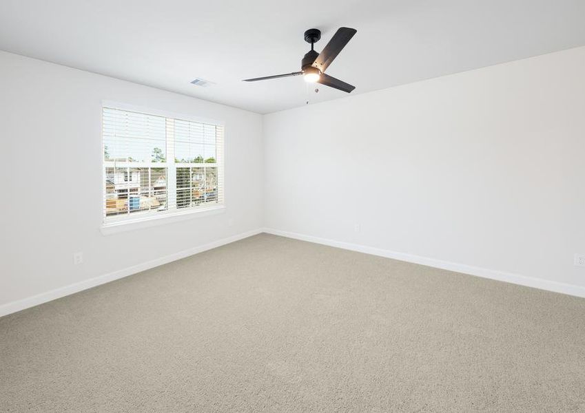 Master bedroom with ceiling fan and large window