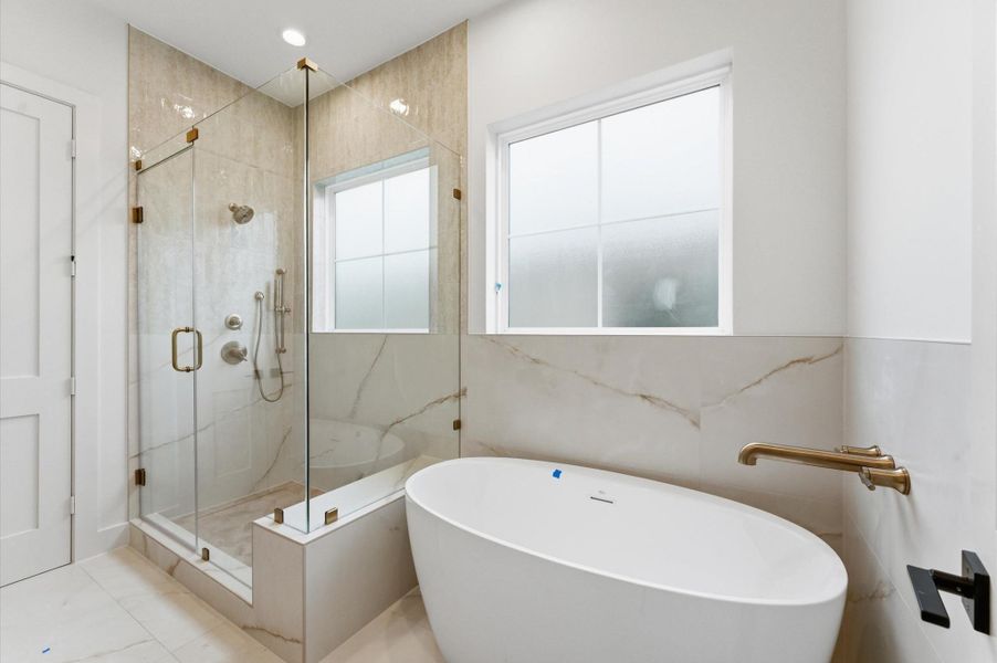 Primary bathroom offers natural light.