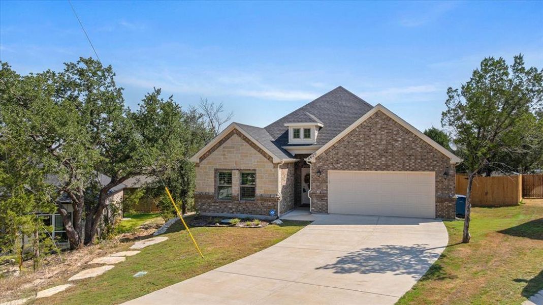 Craftsman-style house featuring concrete driveway, brick siding, an attached garage, and roof with shingles Craftsman-style house featuring concrete driveway, brick siding, an attached garage, and roof with shingles
