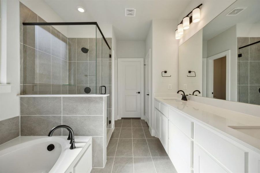 Bathroom with tile patterned flooring, vanity, and independent shower and bath