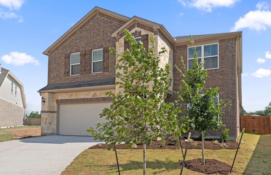 Front exterior of a new home in Lagos, Manor, TX, highlighting curb appeal (Image 22). Front exterior of a new home in Lagos, Manor, TX, highlighting curb appeal (Image 22).