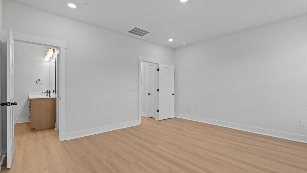 Accomplished primary retreat with eye-catching hardwood flooring in a desirable Anderson community