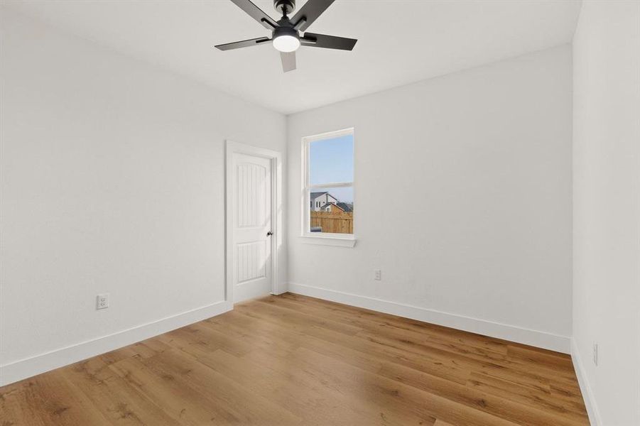 Spare room with light wood-type flooring and ceiling fan Spare room with light wood-type flooring and ceiling fan