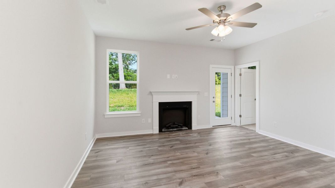 Gathering room with ceiling fan and fireplace