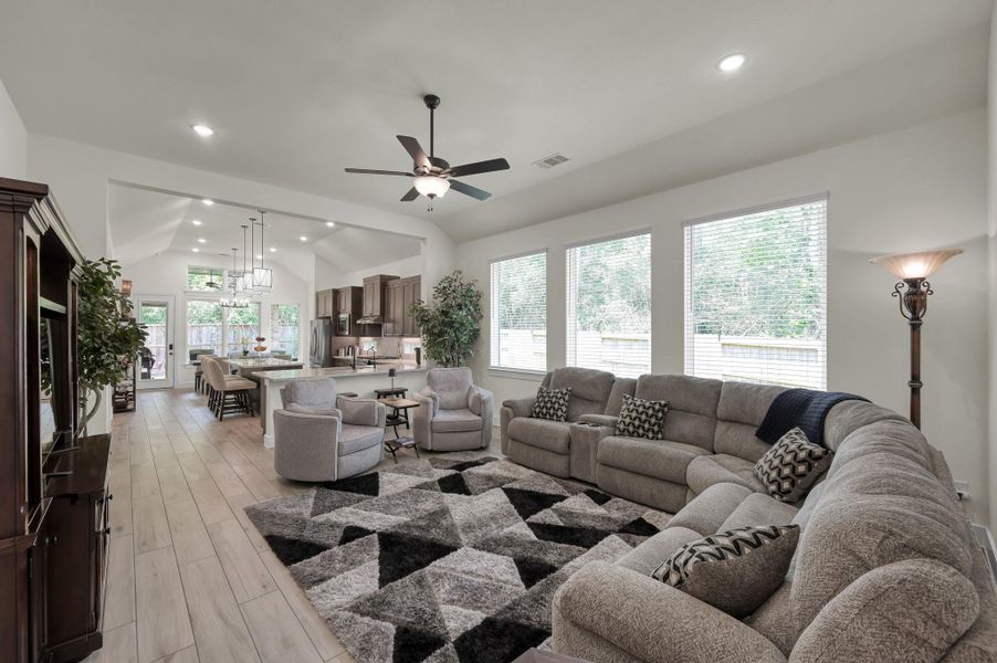 Spacious open-concept living room filled with natural light and designed for both entertaining and everyday comfort, with the option to purchase the beautifully maintained furnishings that are only approximately 1.5 years old.