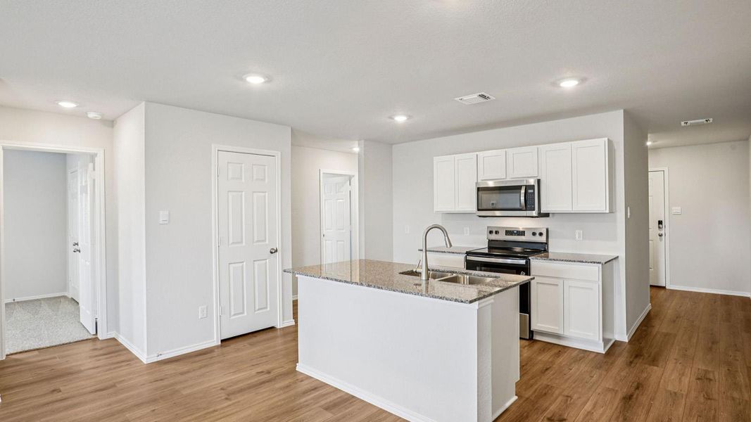 Kitchen island with granite countertop and double stainless steel sink Kitchen island with granite countertop and double stainless steel sink