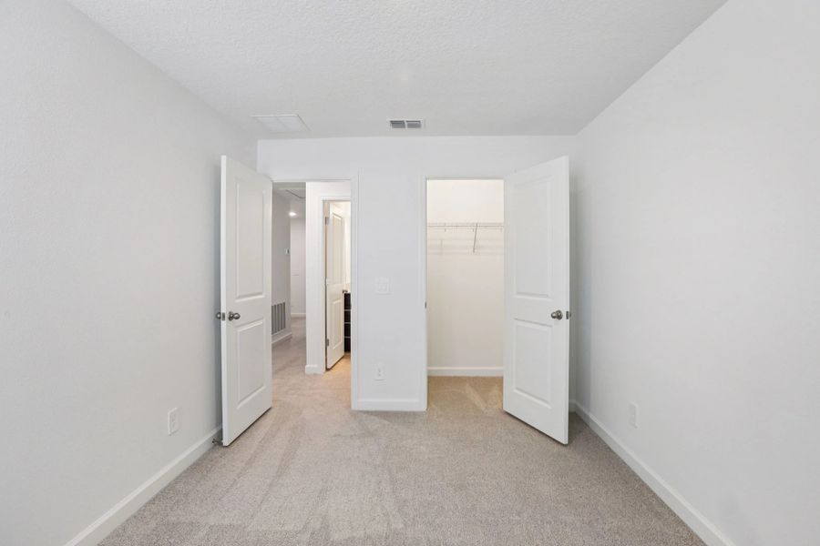 Bedroom 3 features a generous walk-in closet