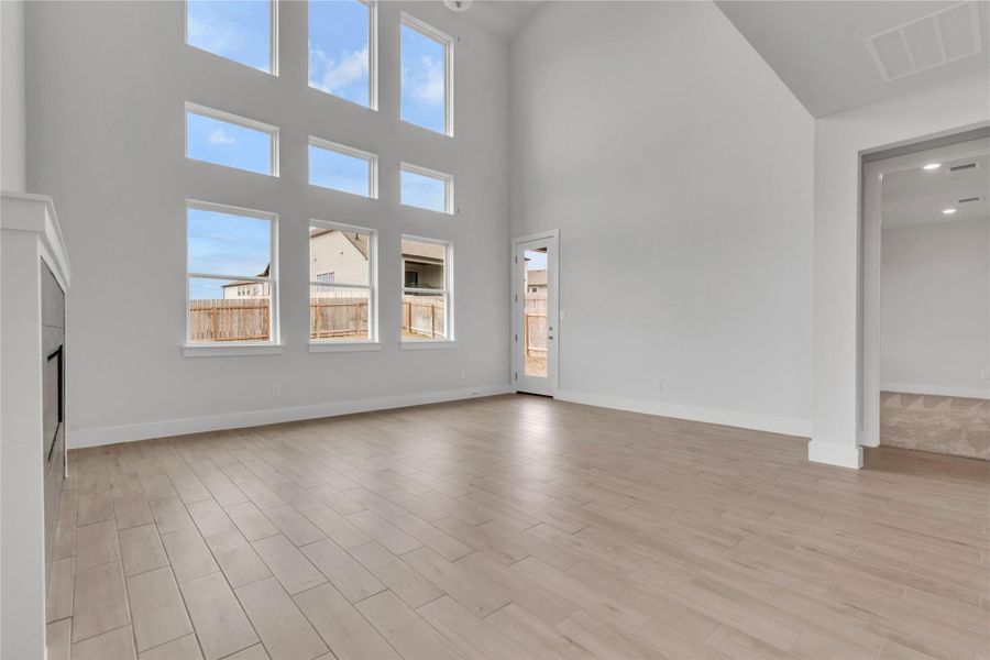 An airy living space features soaring high ceilings and an abundance of natural light.