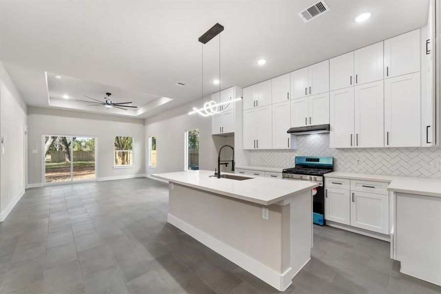 Check out all that storage! With floor-to-ceiling cabinets, sleek stainless steel appliances, a modern undermount sink, and a stylish subway tile backsplash sitting atop durable silestone countertops, this kitchen is both beautiful and functional.