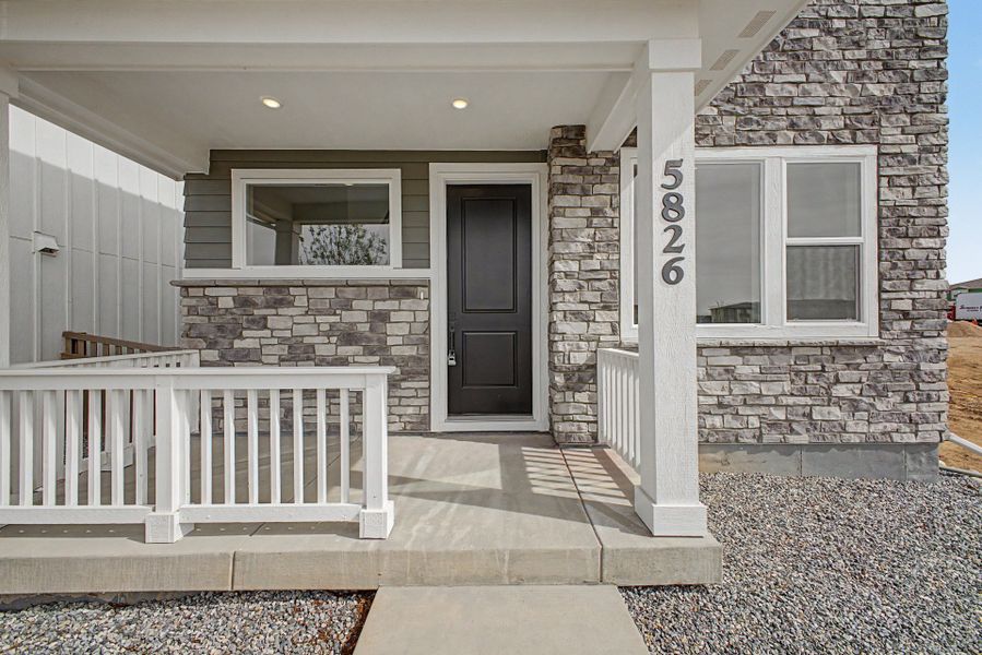Exterior details and patio area of a home in Painted Prairie, Aurora (Image 19).