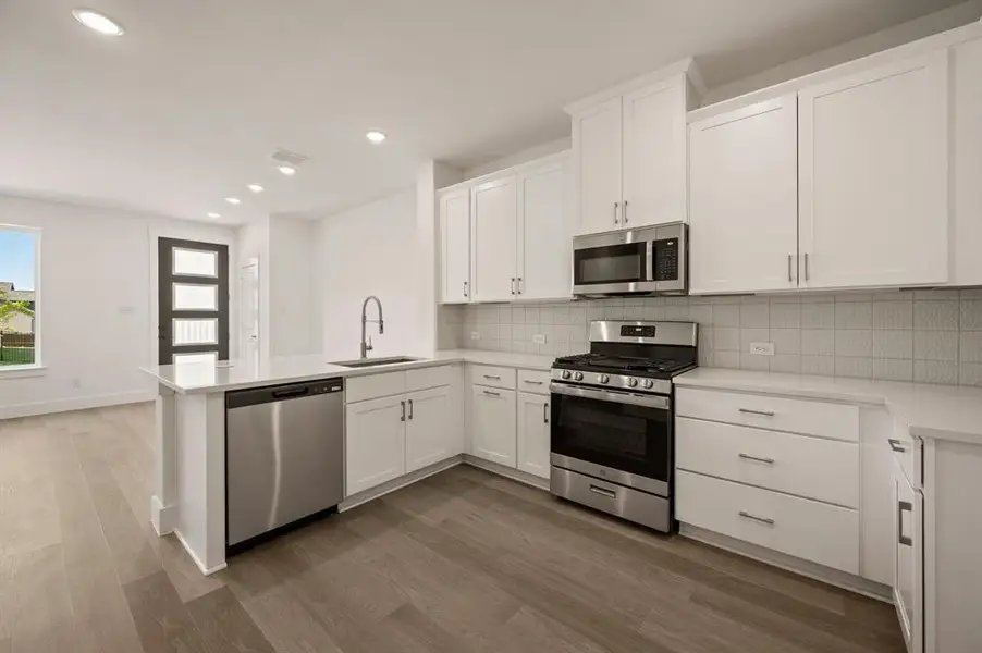 Lovely neutral color cabinets paired with modern stainless steel create the kitchen of your dreams!