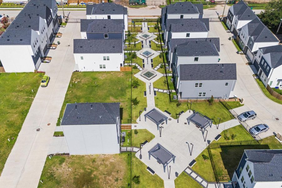 Showcasing the full scope of the neighborhood, this stunning aerial view captures the community’s thoughtful layout, lush green spaces, and inviting shared amenities. This bird’s-eye perspective highlights the seamless blend of architecture and nature. Ideal for getting a true sense of scale, proximity, and lifestyle, this elevated view paints a vivid picture of what it means to live here. Showcasing the full scope of the neighborhood, this stunning aerial view captures the community’s thoughtful layout, lush green spaces, and inviting shared amenities. This bird’s-eye perspective highlights the seamless blend of architecture and nature. Ideal for getting a true sense of scale, proximity, and lifestyle, this elevated view paints a vivid picture of what it means to live here.